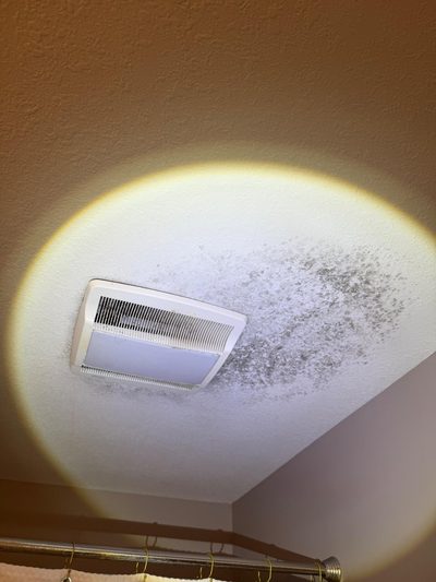 Mold on a bathroom ceiling around the exhaust fan